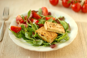 Vegetable salad with smoken tofu, lettuce, tomato and spices