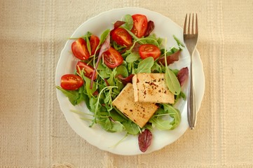 Vegetable salad with smoken tofu, lettuce, tomato and spices