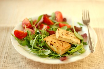 Vegetable salad with smoken tofu, lettuce, tomato and spices