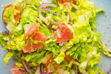 Grapefruit, red onion, lettuce and black pepper salad for light lunch