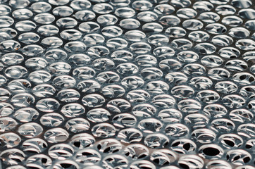 Metal sheets with laser-cut circles. Industrial background.
