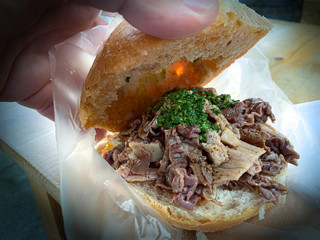 Sandwich of Lampredotto, a typical Florentine dish, made from the fourth and final stomach of a cow, the abomasum, Florence, Italy