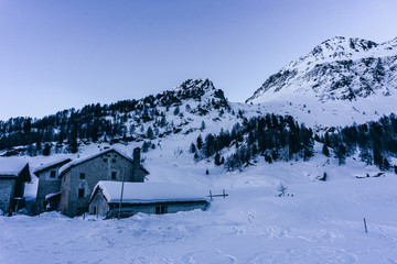 Snowy mountains during a sunny winter day in the alps, near the village of Sankt Moritz and Silvaplana, Switzerland - January 2020