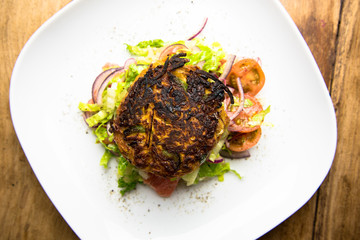 Chargrilled sweet potato and holloumi cakes served with green salad