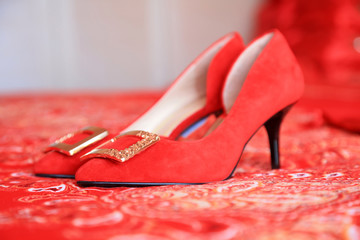 Red high heels on the carpet