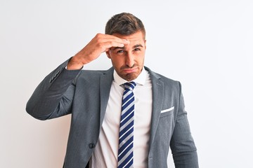 Young handsome business man wearing suit and tie over isolated background worried and stressed about a problem with hand on forehead, nervous and anxious for crisis