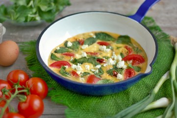 Egg frittata with tomato, onion, basil and cheese