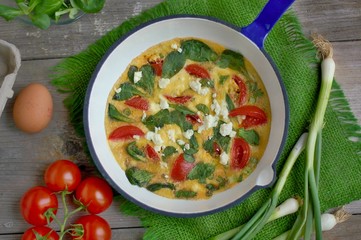 Egg frittata with tomato, onion, basil and cheese