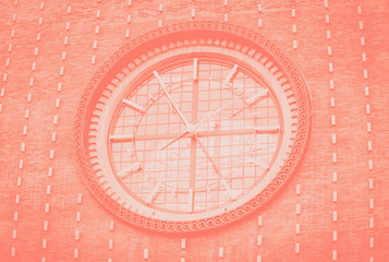 Fototapeta na wymiar Big clock on a dark wall. Church of the most sacred heart of our Lord. Coral color toned. Prague, Czech Republic