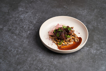 Lamb meat with pickled radish, mushrooms and demi glace sauce