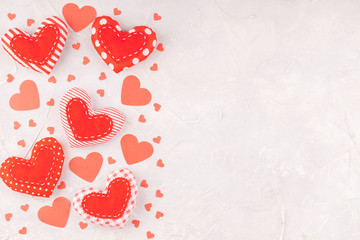Valentine's Background with Confetti Paper and Handmade Textile Stitched Hearts on Concrete Gray Background. Love, Romance, Happy Valentines Day Concept. Top View, Copy Space