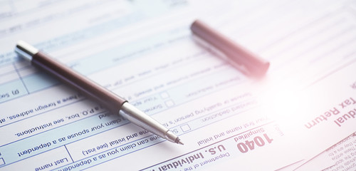 Obraz premium Annual tax reporting. Tax form on the table. Financial statements for signature.