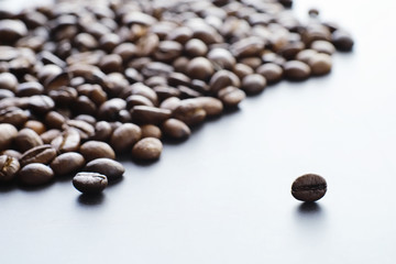 Bag of coffee. Coffee beans roasted on the table. Coffee beans with green leaves for cooking.