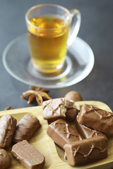 Chocolate bars on a black background in backlight. Chocolate with filling. Sweet sweets for snack and tea.