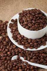 Coffee Cup and coffee beans on the table close-up