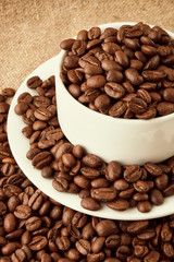 Coffee Cup and coffee beans on the table close-up