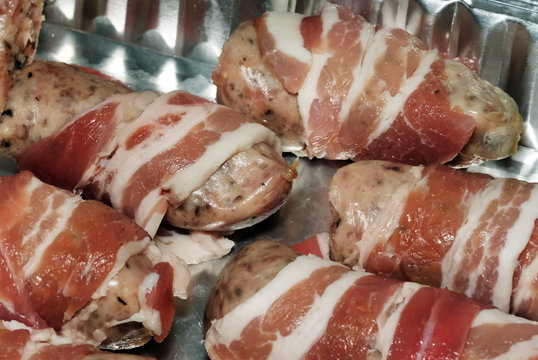 Pigs in lankets. Small pork sausages wrapped in bacon strips.