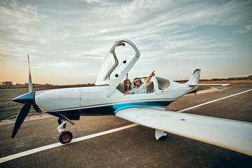 Beautiful couple in love in a small private plane