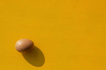 The eggs on the yellow wooden table.