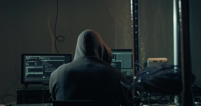 Computer Hacker on Network Computer Coding and Hacking Servers