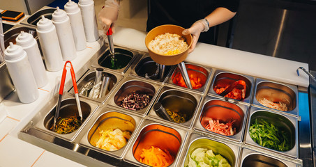 Cooking of poke bowls from ingredients in cafe