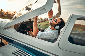 Young pilot is preparing for take off with private plane © HBS