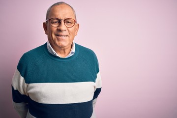 Senior handsome man wearing casual sweater and glasses over isolated pink background with a happy...