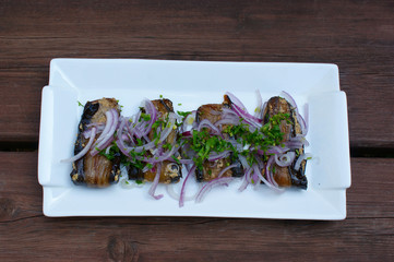 eggplants with walnuts on a white plate. eggplants sprinkled with onions and herbs. vegetarian Georgian food