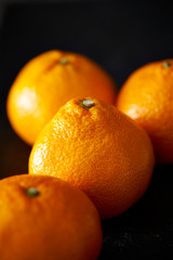 Orange fruit on black background 