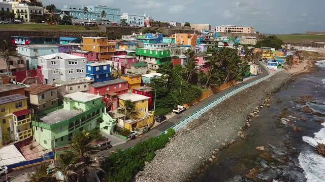 Colorful Houses on Coast of San Juan City, Puerto Rico. Aerial View of Vivid La Perla Neighborhood and Ocean Waves