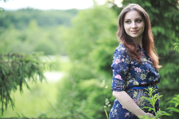 Fototapeta premium Pregnant girl in a dress in nature