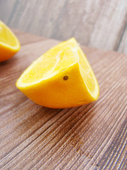 A slice of orange on the wooden table
