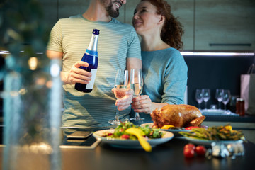 Happy couple embracing before home supper stock photo