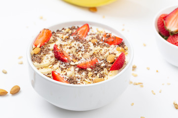 Healthy breakfast, smoothie bowl with granola, chocolate, banana, strawberry and almond. 