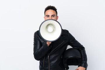 Man with a motorcycle helmet shouting through a megaphone