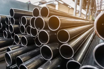 Fotobehang high quality Galvanized steel pipe or Aluminum and chrome stainless pipes in stack waiting for shipment  in warehouse © kasarp
