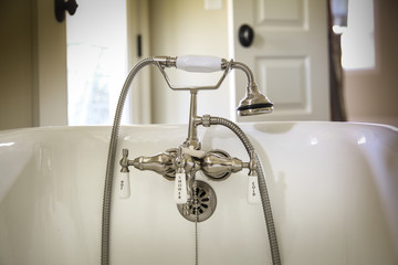 Old style water spigot on claw foot tub
