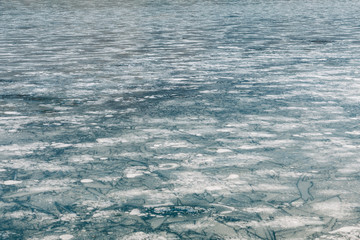 Surface of the frozen lake in winter time