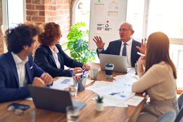 Group of business workers smiling happy and confident. Speaking with smile on face working together at the office.