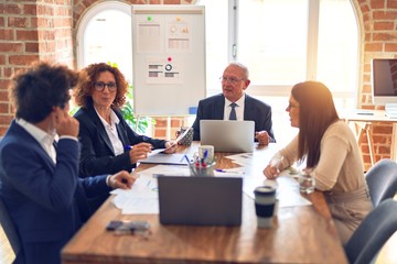Group of business workers smiling happy and confident. Speaking with smile on face working together at the office.