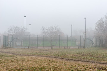 Novi Sad, Serbia - January 16, 2020: An outdoor basketball hoop in the fog. Basketball court outside
