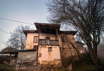 A series of misty landscapes in winter. An abandoned old house near a rural path in a mountain village Smolichano in the Osogovo Balkan. Bulgaria.