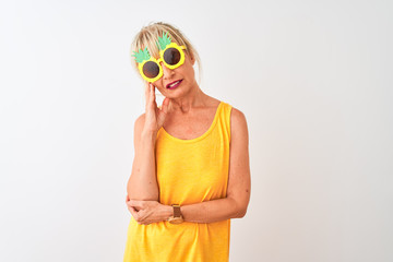 Middle age woman on vacation wearing pineapple sunglasses over isolated white background thinking looking tired and bored with depression problems with crossed arms.
