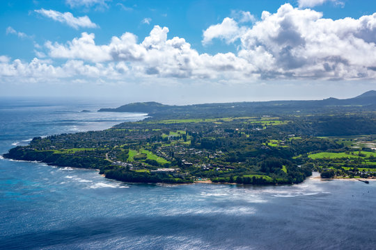 Aerial view of Kauai's lush Princeville area landscape next to Hanalei Bay.
