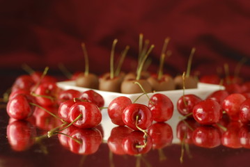 ripe red cherries on a red background