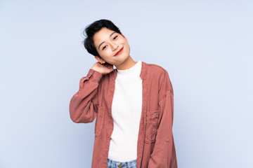 Young Asian girl over isolated blue background thinking an idea