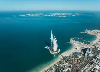  Aerial view from a plane of Dubai Jumeirah district cityscape and world islands on a sunny day. Dubai, United Arab Emirates. © Kertu