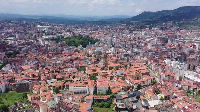 anoramic aerial view of Oviedo city surrounded by mountain ranges on sunny summer day, Asturias, Spain