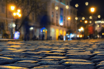 paving stones with reflection and lens flare night lights, night city abstract background and texture