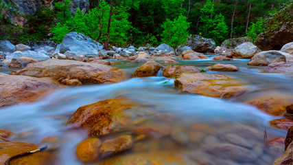 mountain river rushing among a huge stones in canyon, outdoor river natural background